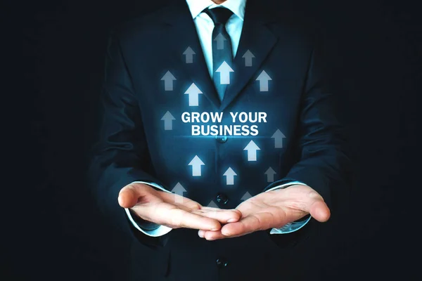 Man Holding Grow Your Business Words Growth Arrows — Stock Photo, Image