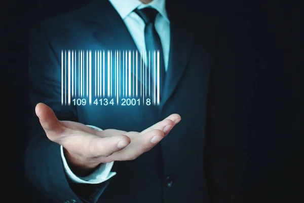 Businessman showing bar code. Warehouse, logistic and financial concept