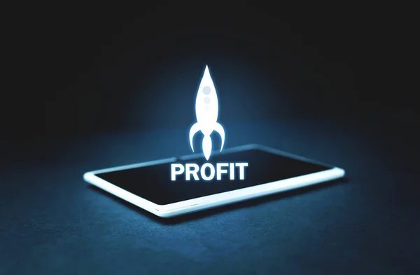 Profit rocket on tablet screen. Business concept