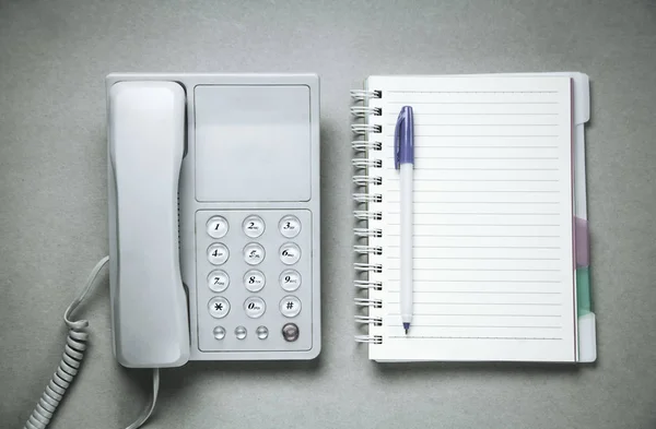 Office phone with notepad and pen. Business concept