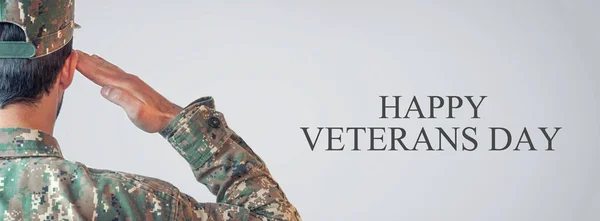 Caucasian Soldier Saluting Veterans Day.