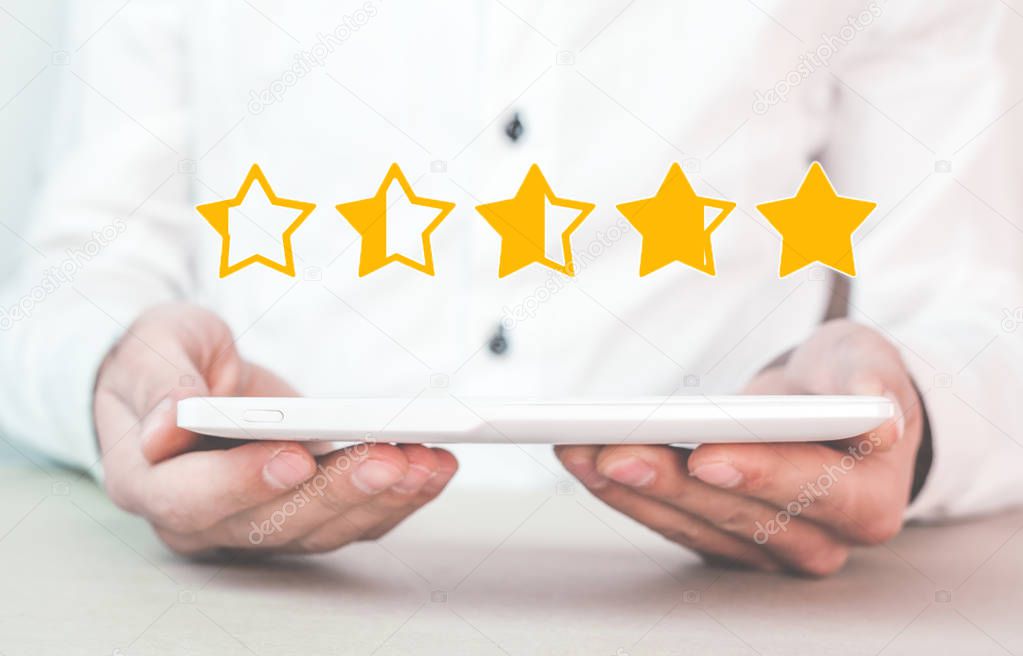 Man holding tablet. Five stars. Increase rating