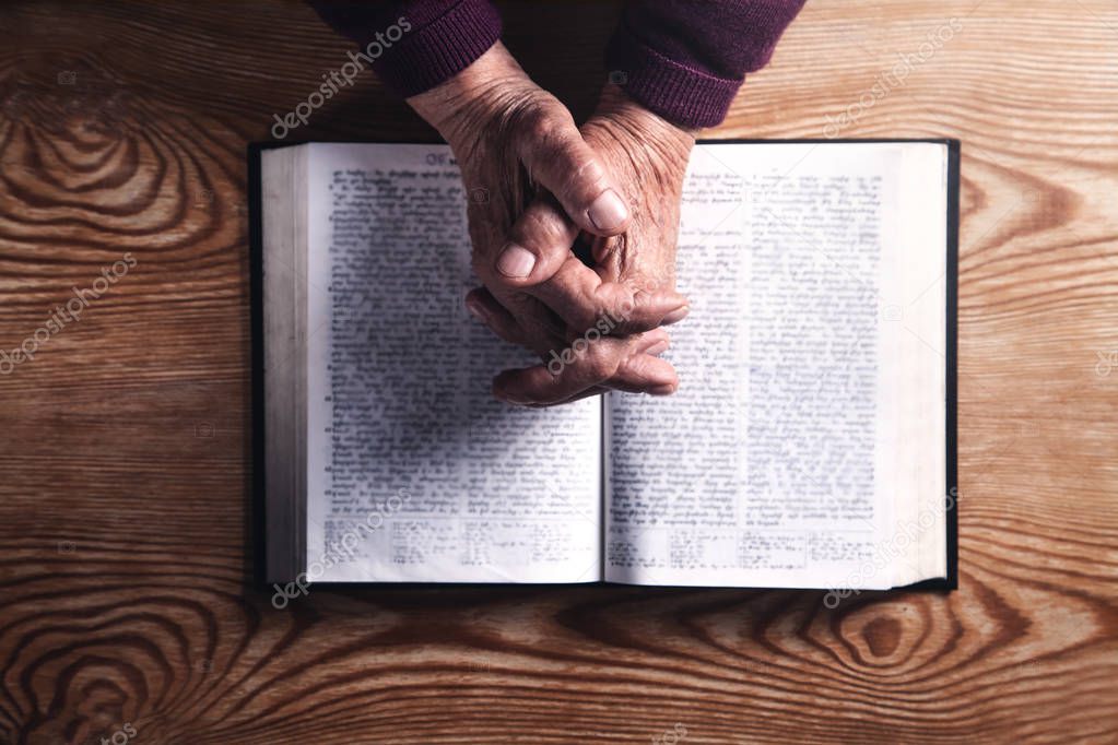 Hands of elderly woman praying. Religion concept