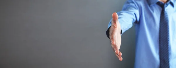 Businessman offering hand for handshake. Deal concept