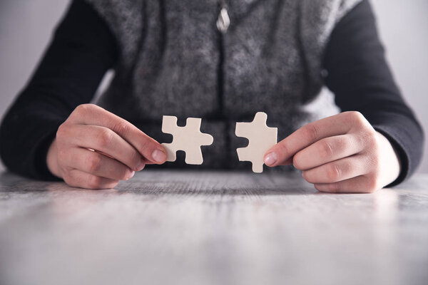 Hands holding jigsaw puzzle piece. Business Solution, Success