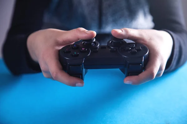 Hands using game controller. Playing video games