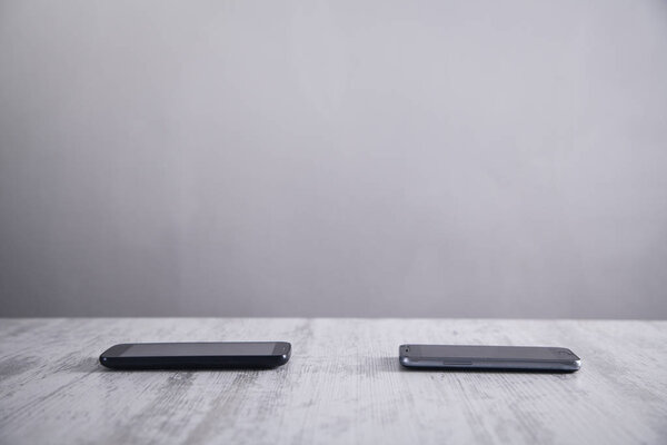 Smartphones on white modern desk.