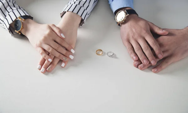 Masa üzerinde yüzük ile erkek ve kadın eller. — Stok fotoğraf