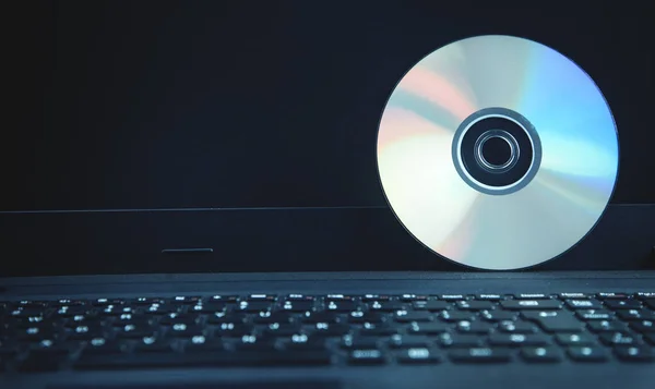 DVD disk on the laptop keyboard.