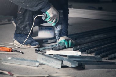 Master metal profilde bir delik açar. Sanayi