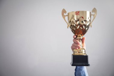 Altın kupayı elinde tutan bir iş adamı. İş, Başarı