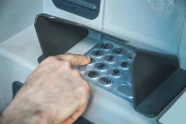 Man hand pressing on ATM machine keypad. ATM. Withdraw money