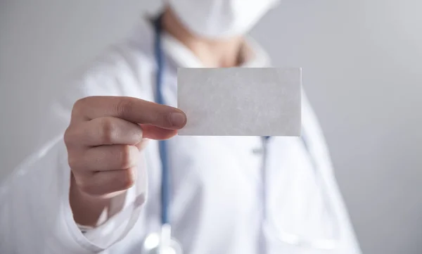Doctor holding empty business card. Health and Medical