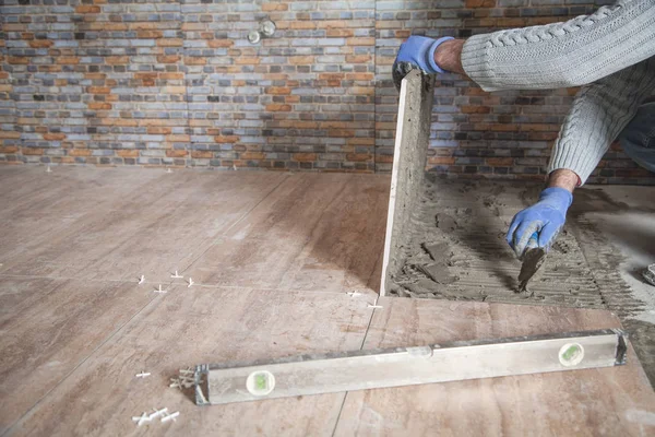 Laying floor ceramic tile. Renovating the floor