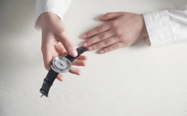 Hand with wristwatch on white desk. — Stock Photo, Image