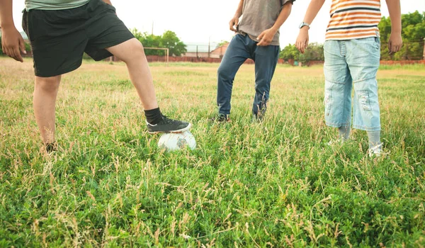 Caucasian boys with a soccer ball on a football field. — Stock Photo, Image