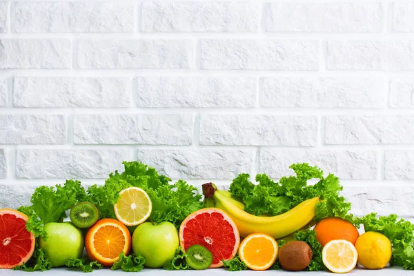 Healthy food fruits grapefruit, lemon, kiwi, apple, banana, orange, green