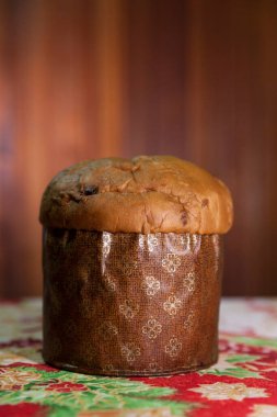 Panettone on the table with a Christmas tablecloth. Panettone concept. Christmas concept. copy space.	