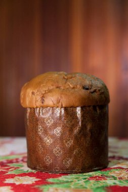 Panettone on the table with a Christmas tablecloth. Panettone concept. Christmas concept. copy space.	