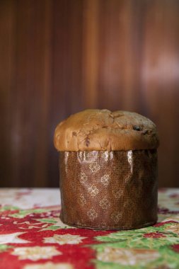Panettone on the table with a Christmas tablecloth. Panettone concept. Christmas concept. copy space.	
