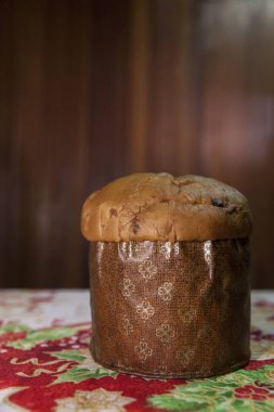 Panettone on the table with a Christmas tablecloth. Panettone concept. Christmas concept. copy space.	