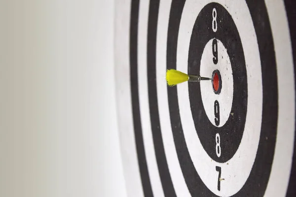 Bulls eye! A dart from an air gun is about to hit a dartboard