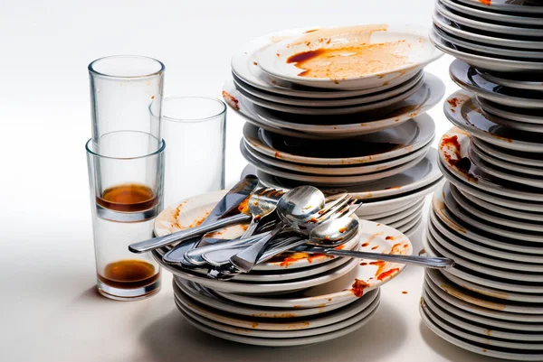 Close up of dirty dishes on white background.