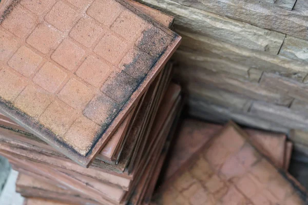 stack of brown square tiles for floor construction