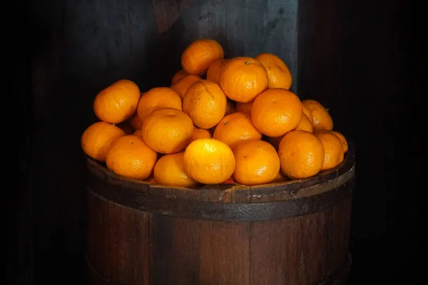 oranges in a barrel dark background