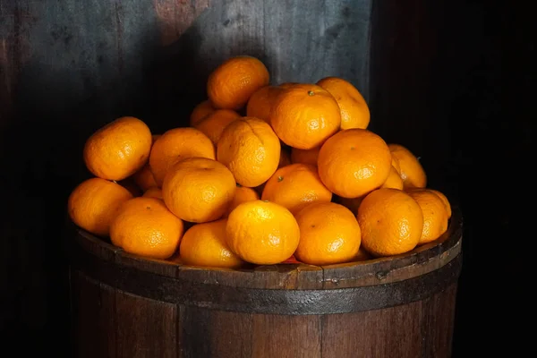 oranges in a barrel dark background