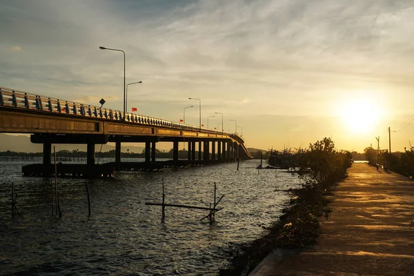 bridge over river, sea morning sun rise, boat, elephant flag Thailand