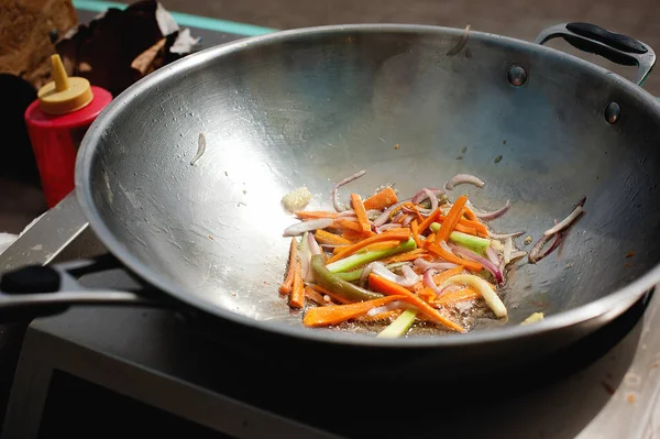 roasting vegetables in a wok pan. Street food. Asiasn food