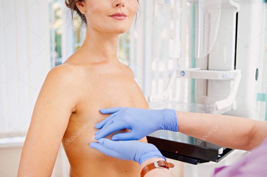 doctor examining woman breast - Cancer prevention. Manual breast examination