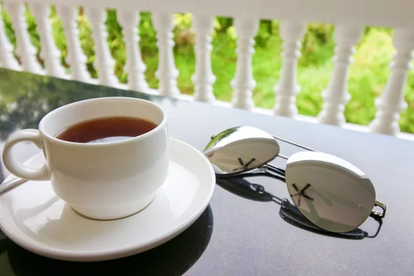 Cup Tea Spoon Plate Black Table Decorated Sunglasses — Stock Photo, Image