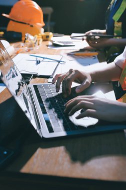 Endüstriyel mühendislerden oluşan bir ekip, fabrikadaki masada bulunan makine planlarını analiz ediyor. Fabrikada ya da üretim tesisinde çalışıyorum..