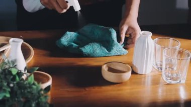 close up view of a woman hands washing dishes with soap