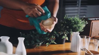 woman preparing green plant in the kitchen