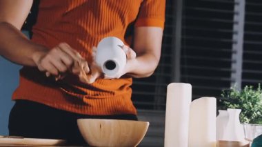 young man in apron cooking on wooden table in kitchen