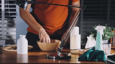 cropped shot of woman using smartphone at kitchen counter
