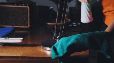 a man playing a guitar on a wooden table