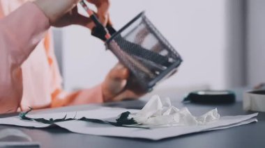 close up of a woman 's hands writing in a notepad.