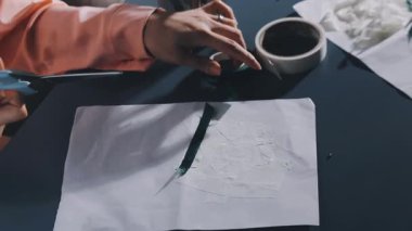 close up of female designer drawing on paper