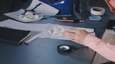 woman making paper rolls with paper in the kitchen