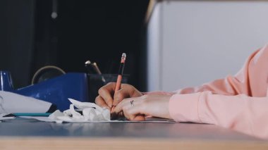 close up of woman hand drawing on paper