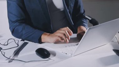 close up. a young business woman working on a laptop in the office.