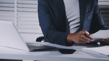 young business man working with documents and computer in office.