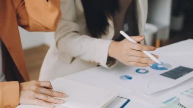 close up. two young business women discussing a financial report