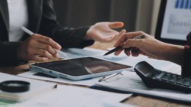 business people discussing financial charts at the desk.