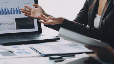 close up of a businessman working with a laptop and analyzing data in the office.