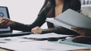 businesswoman with tablet computer at table in office